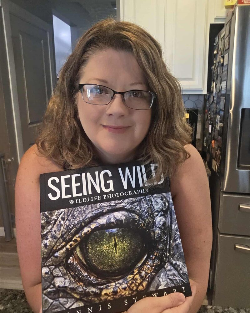 Reader holding a copy of Seeing Wild