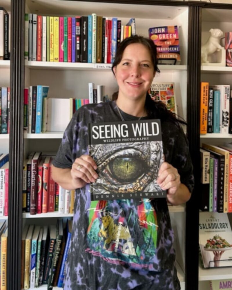 Reader holding Seeing Wild inside a bookstore