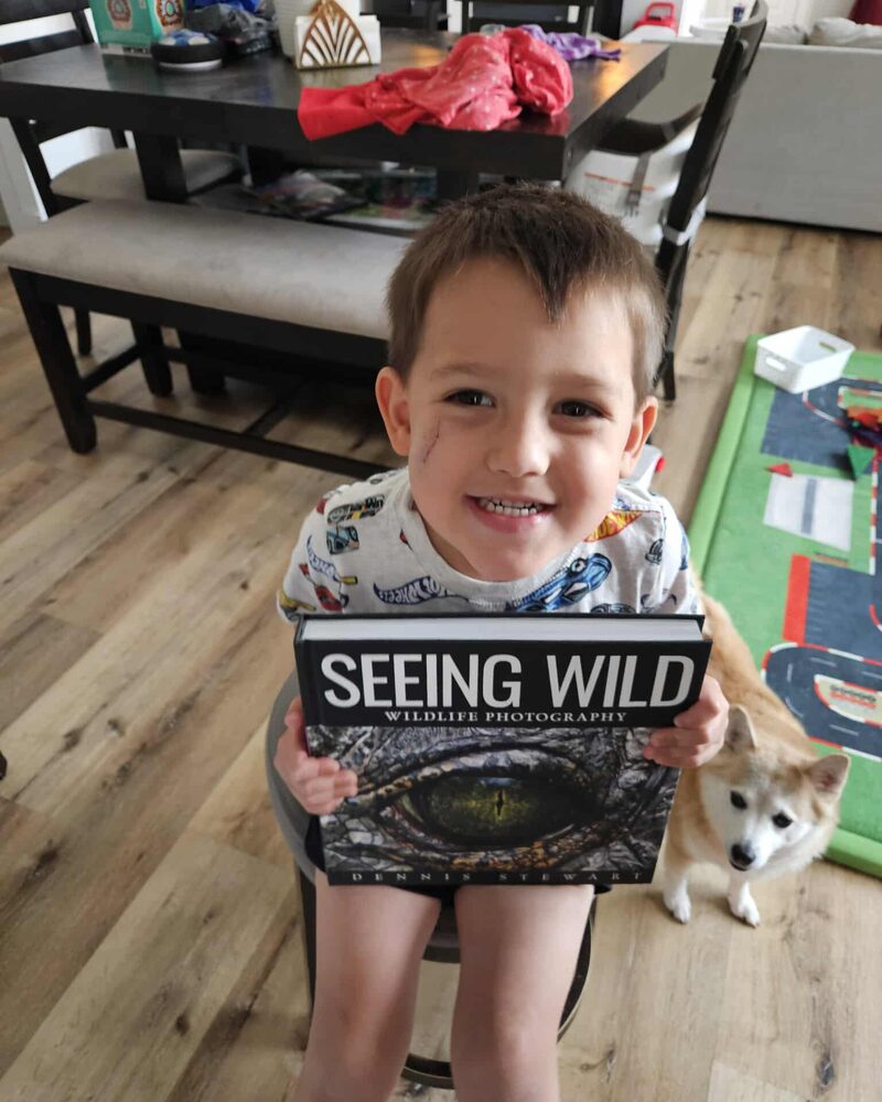 Young child proudly holding Seeing Wild
