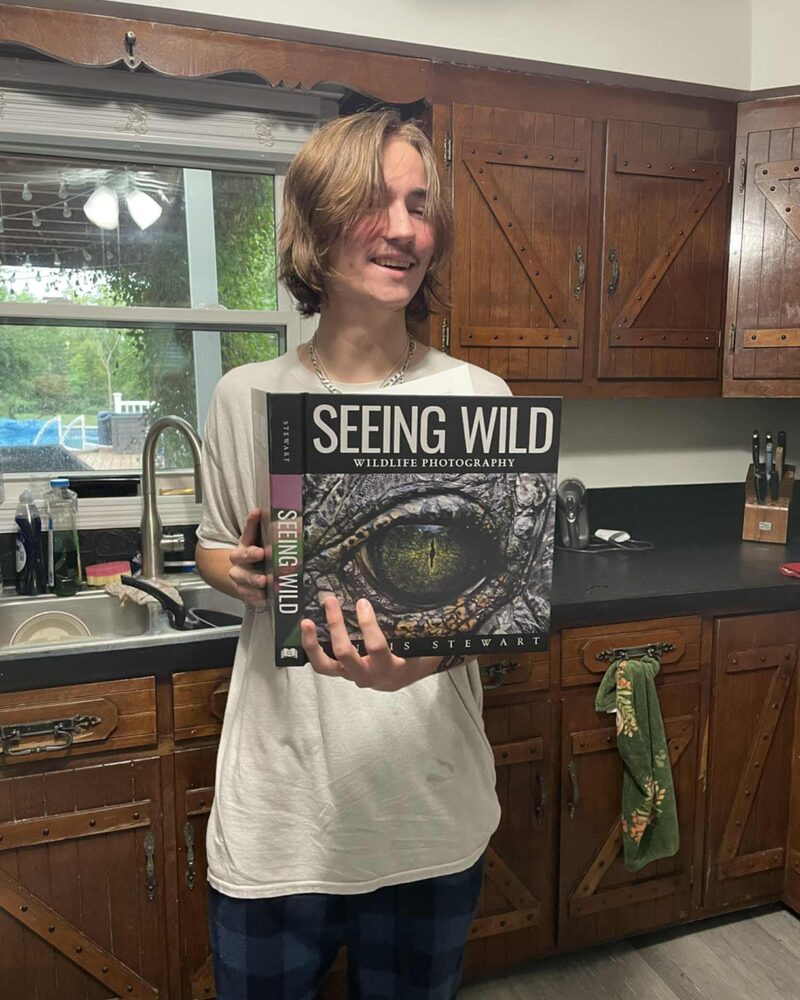 Reader holding Seeing Wild at home