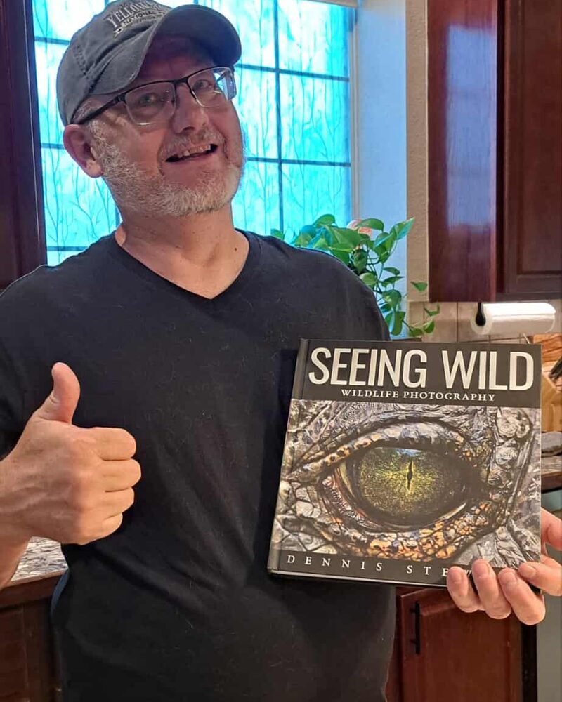 Reader giving a thumbs-up while holding Seeing Wild